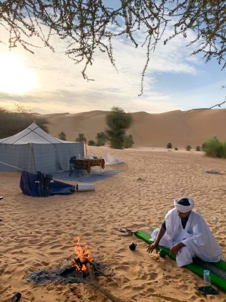 Tea is made at an encampment site at the foot of the big dunes of Azouega