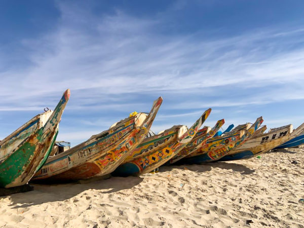 Colorful fishing boats line the waterfront in Nouakchott