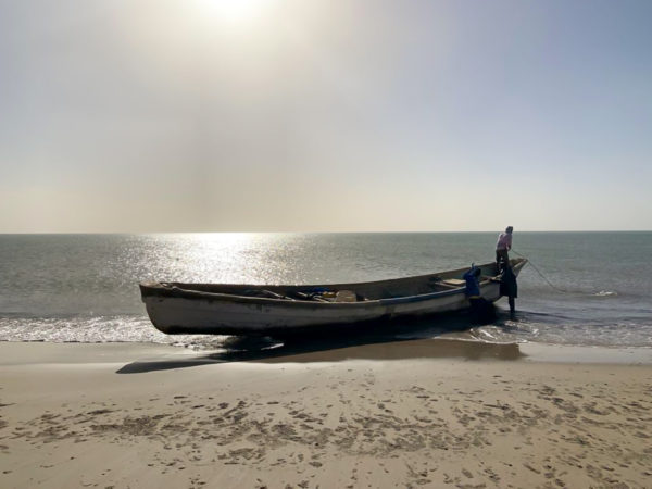 An empty boat shored on the beach