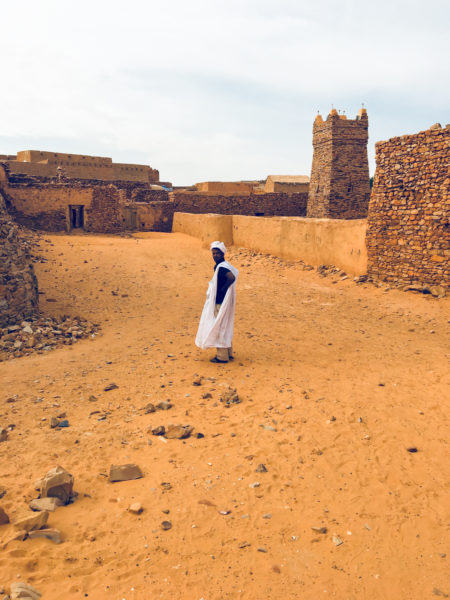 Sidi stands in an open square in Chinguetti